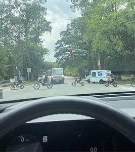 Teenagers riding E-bikes crossing Alp Road on Nellis Drive in Wayne, NJ